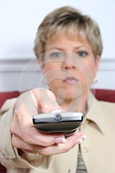 Beautiful Woman Aiming Remote with Light Off