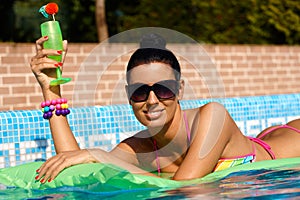 Beautiful woman on airbed sunbathing