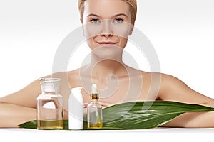 Beautiful woman applies organic cosmetic and oils for beauty. Spa and wellness. Clean skin, shiny hair. Healthcare