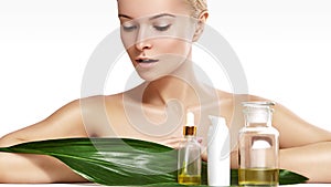 Beautiful woman applies organic cosmetic and oils for beauty. Spa and wellness. Clean skin, shiny hair. Healthcare