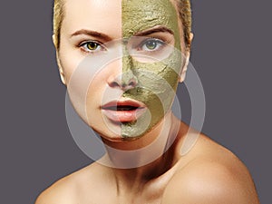 Beautiful Woman Applying Green Facial Mask. Beauty Treatments. Close-up Portrait of Spa Girl Apply Clay Facial mask