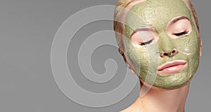 Beautiful Woman Applying Green Facial Mask. Beauty Treatments. Close-up Portrait of Spa Girl Apply Clay Facial mask