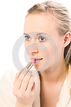 Beautiful woman applying lipstick.