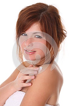 Beautiful woman applying moisturiser cream photo