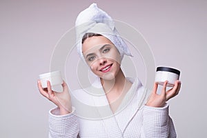 Beautiful woman applying moisturizer cream her face. Beauty concept. Skincare and pampering. Anti aging cream. Young