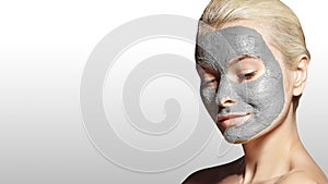 Beautiful Woman Applying White Facial Mask. Beauty Treatments. Spa Girl Apply Clay Facial mask on grey background