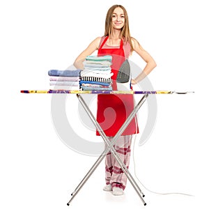 Beautiful woman in apron stack towels clean clothes ironing board iron