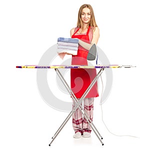 Beautiful woman in apron stack towels clean ironing board iron