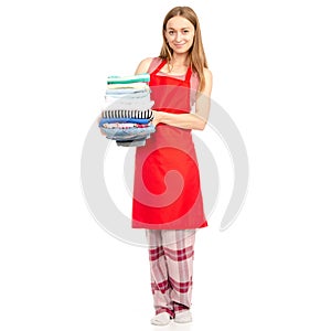 Beautiful woman in apron stack towels ironed clean clothes in hand