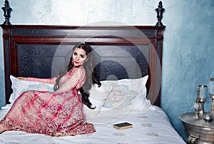 Beautiful woman arabic dress silk fashion harem bed photo