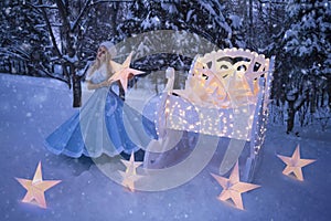 Beautiful woman as snow maiden with sled and stars