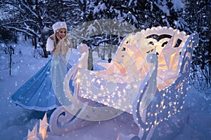 Beautiful woman as snow maiden with sled and stars