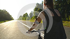 Beautiful woman athlete riding a Bicycle on the road