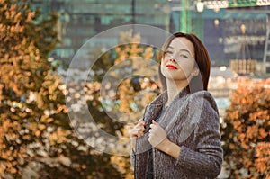 Beautiful woman in the autumn city park