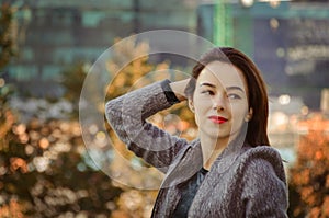 Beautiful woman in the autumn city park