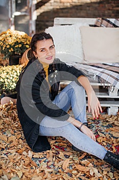 Beautiful woman in autumn garden with a yellow foliage