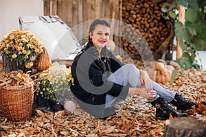 Beautiful woman in autumn garden with a yellow foliage