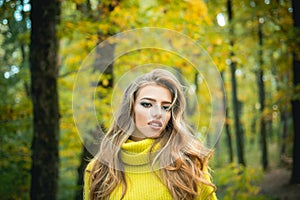 Beautiful Woman with Autumn Leaves on Fall Nature Background. Outdoor portrait Gorgeous brunette model girl with sunny