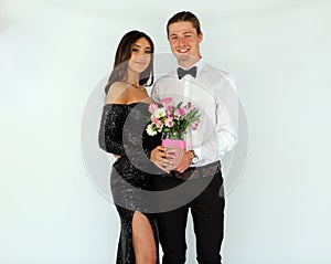 Beautiful woman in back prom dress and handsome guy in suit, teenager ready for a luxury night.