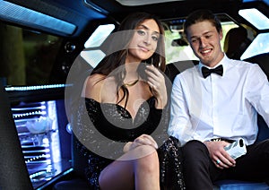 Beautiful woman in back prom dress and handsome guy in suit, teenager ready for a luxury night.