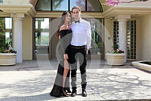 Beautiful woman in back prom dress and handsome guy in suit, teenager ready for a luxury night.