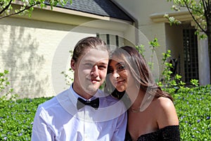 Beautiful woman in back prom dress and handsome guy in suit, teenager ready for a luxury night.