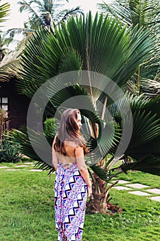 Beautiful woman on a background of palm trees.