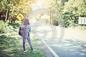 Beautiful woman backpack relaxing on the road. Vacation time and summer