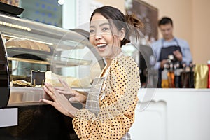 Beautiful woman bakery or coffee shop owner is smiling in her shop