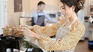 Beautiful woman bakery or coffee shop owner is smiling in her shop