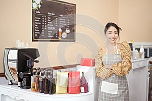 Beautiful woman bakery or coffee shop owner is smiling in her shop