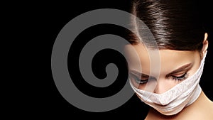 Beautiful woman with bandage mask on face. Fashion eye make-up. Beauty surgery or protection hygiene in virus pandemic