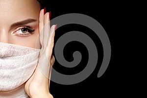 Beautiful woman with bandage mask on face. Fashion eye make-up. Beauty surgery or protection hygiene in virus pandemic