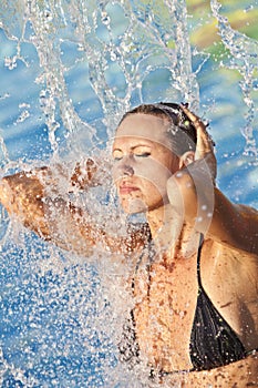 Beautiful woman bathes in pool