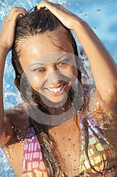 Beautiful woman bathes in pool