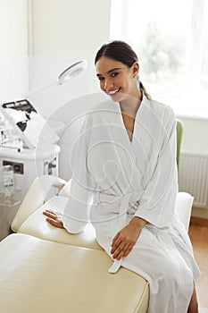 Beautiful Woman In Bathrobe In Cosmetology Room At Spa Salon