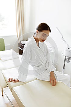 Beautiful Woman In Bathrobe In Cosmetology Room At Spa Salon