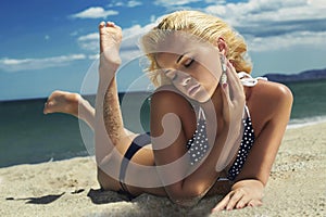 Beautiful woman on the beach. Blond girl in bikini. summer holidays