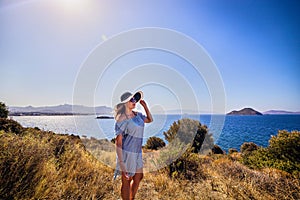 Beautiful woman in beach hat enjoying sea view with blue sky at sunny day in Bodrum, Turkey. Vacation Outdoors Seascape Summer