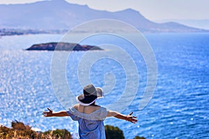 Beautiful woman in beach hat enjoying sea view with blue sky at sunny day in Bodrum, Turkey. Vacation Outdoors Seascape Summer