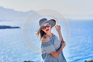 Beautiful woman in beach hat enjoying sea view with blue sky at sunny day in Bodrum, Turkey. Vacation Outdoors Seascape Summer