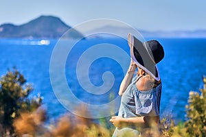 Beautiful woman in beach hat enjoying sea view with blue sky at sunny day in Bodrum, Turkey. Vacation Outdoors Seascape Summer