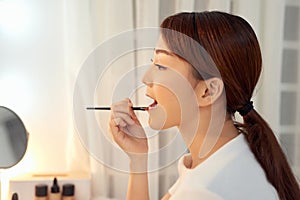 Beautiful Woman With Beauty Face Applying Lip Balm, Lipcare Stick On. Lips skincare cosmetics concept