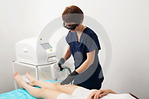 Beautiful woman in beauty studio getting laser hair removal procedure