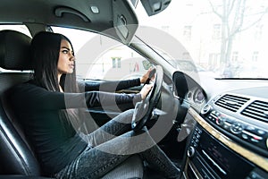 Beautiful woman beep in the car in panic while drive photo