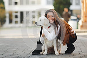 Beautiful woman with beloved dog outdoors