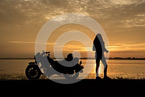 Beautiful Woman biker enjoying sunset, female riding motorcycle. motorbike driver traveling the world, Relaxing after long trip, f