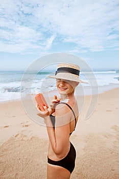 Beautiful Woman in Bikini Applying Sun Cream on Tanned Shoulder. Sun Protection. Skin and Body Care. Girl Using Sunscreen to Skin.