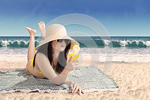 Beautiful woman in bikini lying on a beach