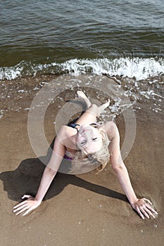 Beautiful woman in bikini sunbathing seaside